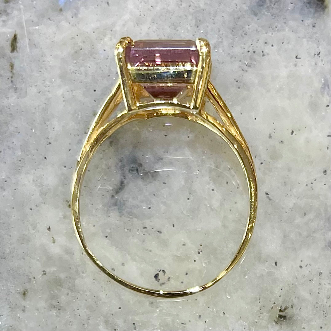 A split shank solitaire ametrine ring made with 14kt yellow gold.