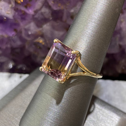 A split shank solitaire ametrine ring made with 14kt yellow gold.