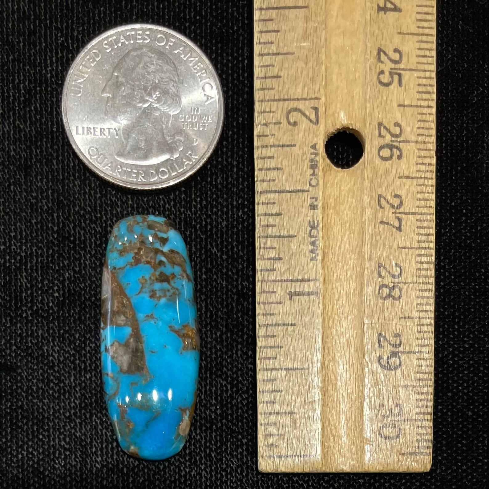 A loose, barrel cabochon cut turquoise stone from the Courtland-Gleeson mine.