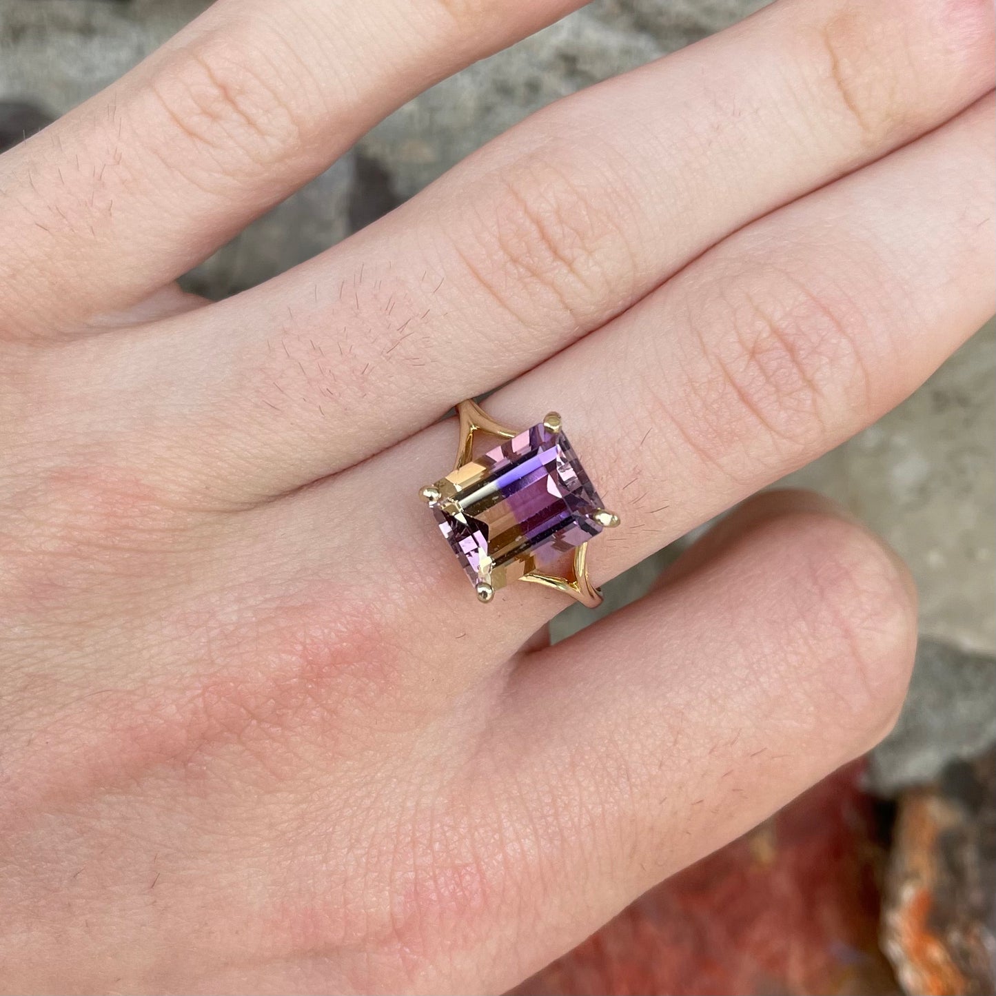 A split shank solitaire ametrine ring made with 14kt yellow gold.