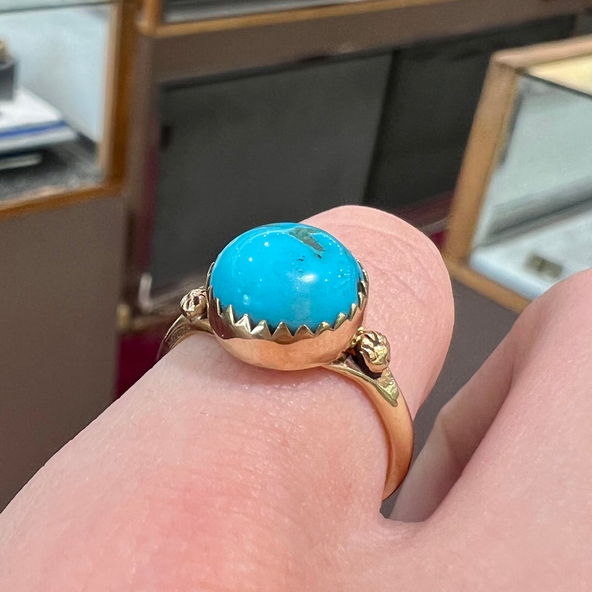 A ladies' yellow gold turquoise ring.  The turquoise is a round cabochon cut.