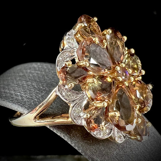 A yellow gold andalusite and diamond cluster ring.