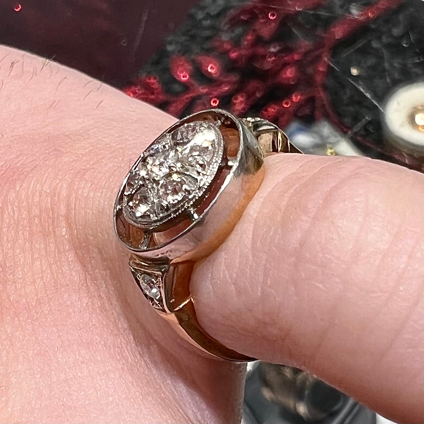 An antique yellow gold ring set with a cluster of old European cut diamonds.