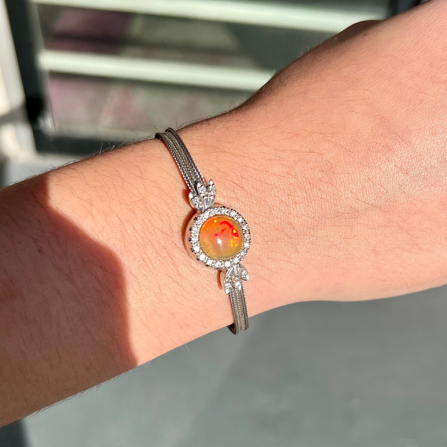 A Virgin Valley fire opal and diamond bracelet made from a vintage 1930's watch.