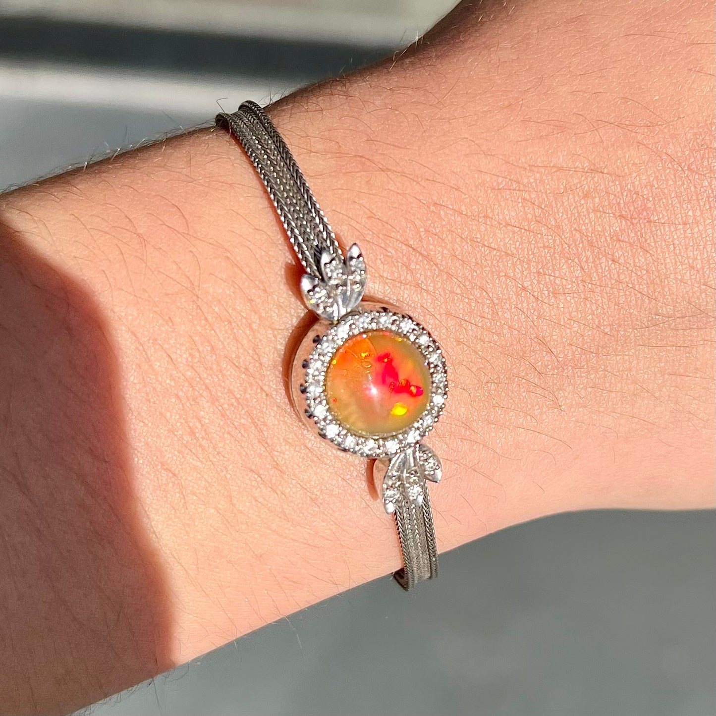 A Virgin Valley fire opal and diamond bracelet made from a vintage 1930's watch.