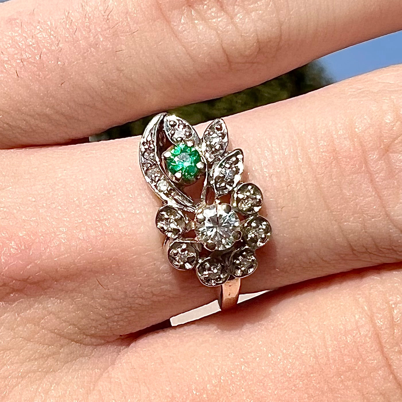 Vintage gold round cut emerald and diamond ring.