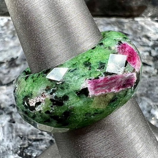 A faceted, carved stone ring made form ruby in zoisite.