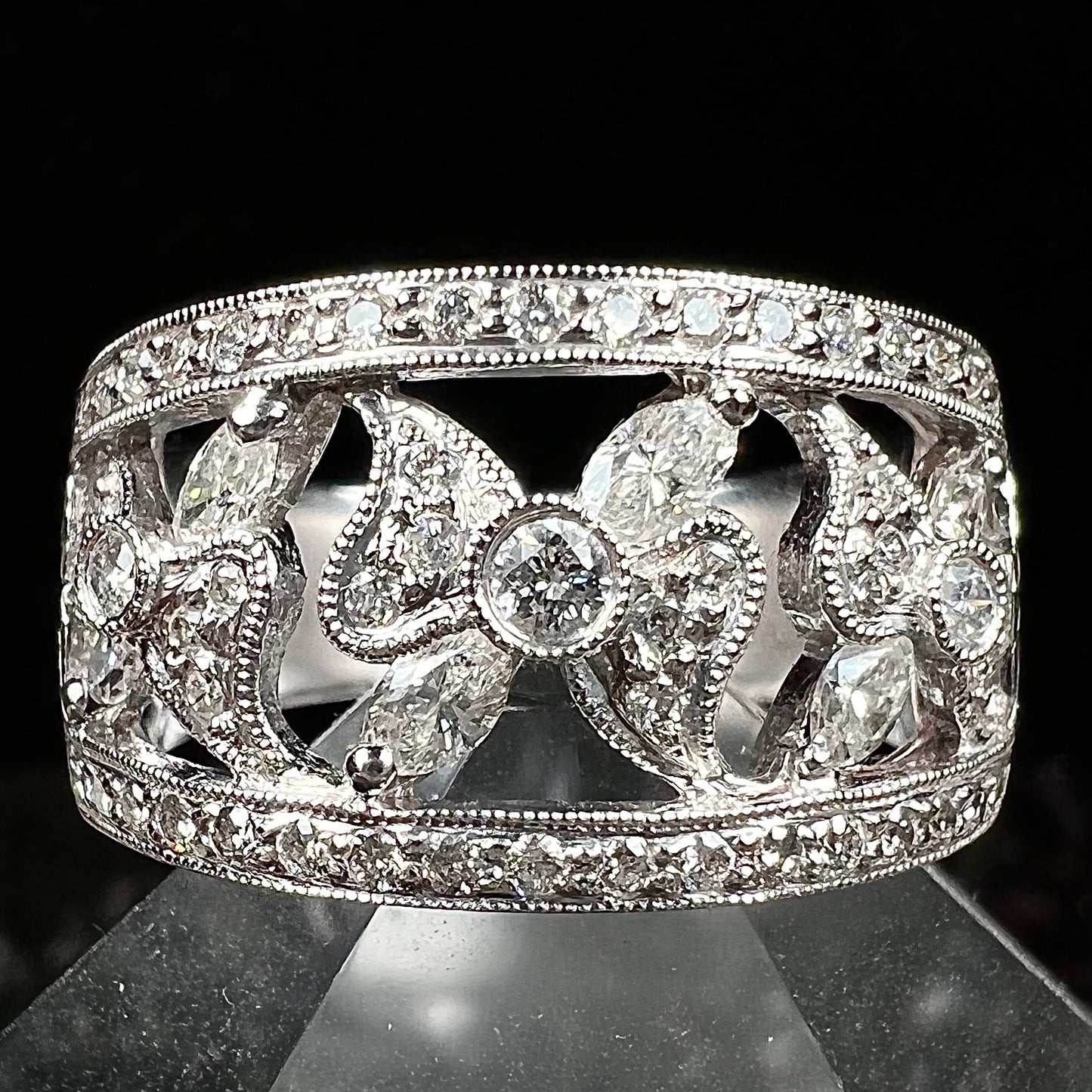 An art nouveau style 18k white gold ring set with round and marquise cut diamonds.