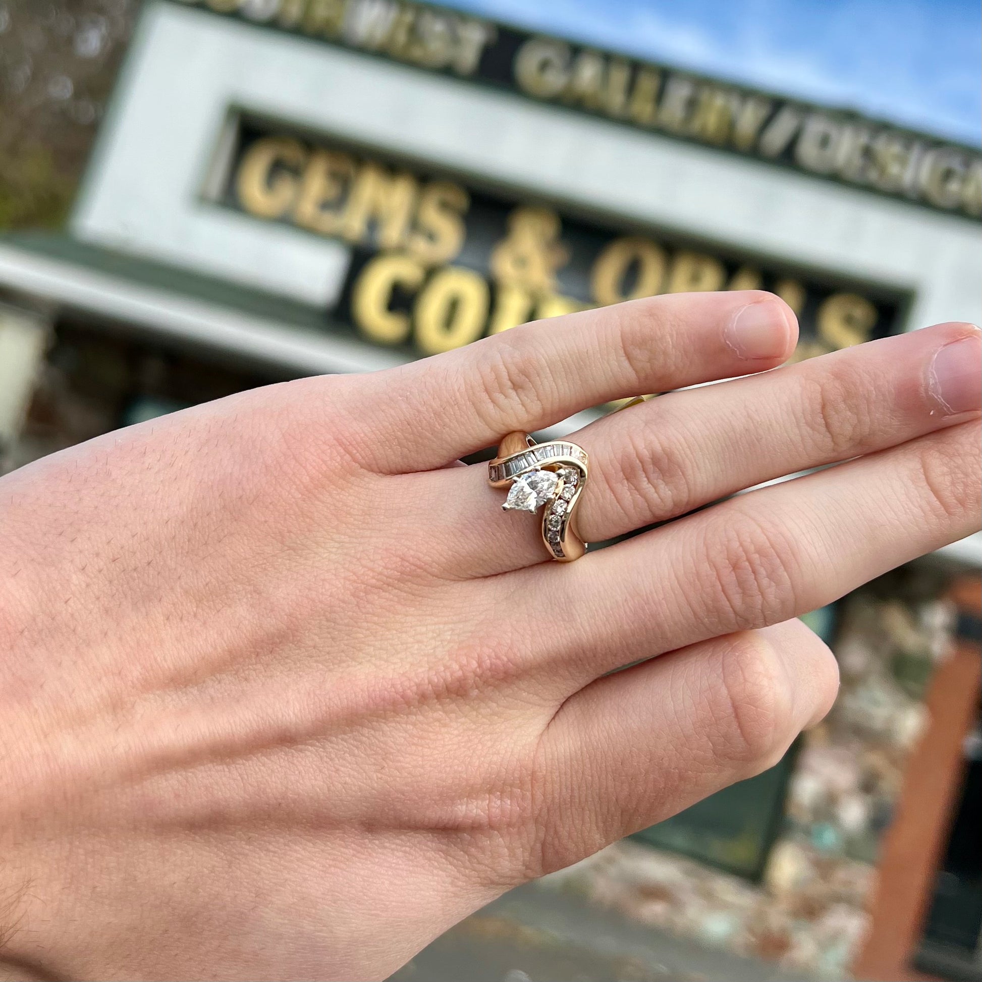 A ladies' marquise cut diamond engagement ring set with round and tapered baguette cut diamond accents.