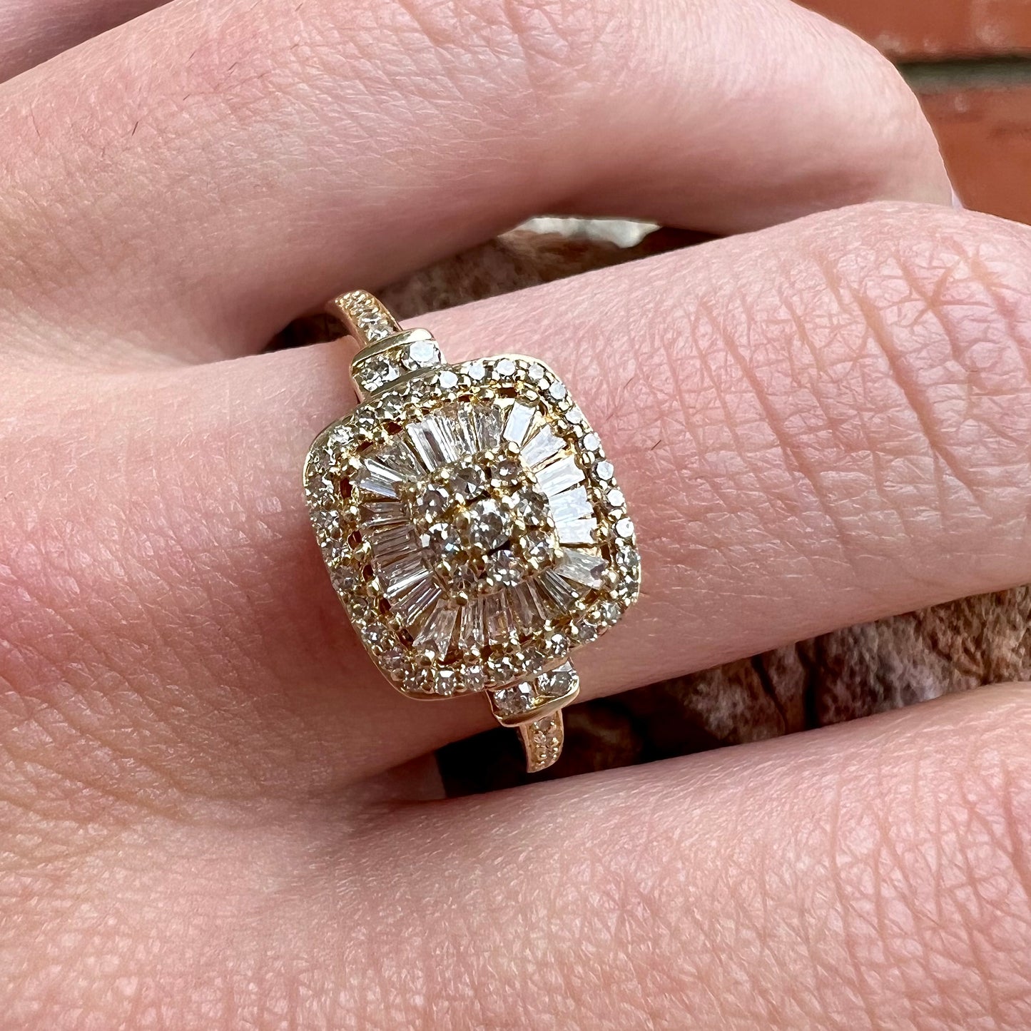 A 1930's style yellow gold diamond cluster ring set with round and baguette cut diamonds.