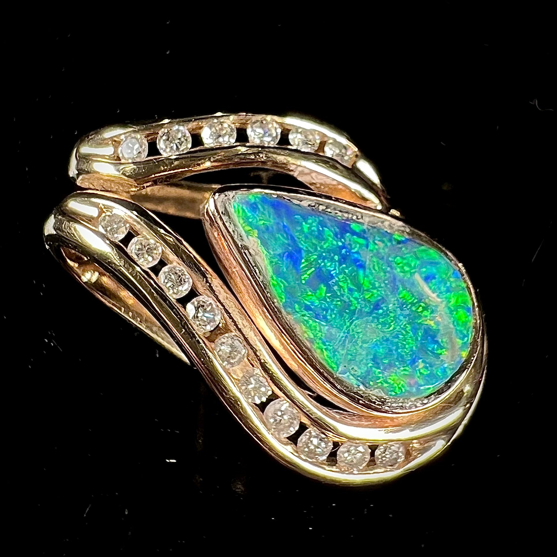 A ladies' yellow gold slider pendant set with a pear shaped Lightning Ridge, Australian black crystal opal and diamonds.