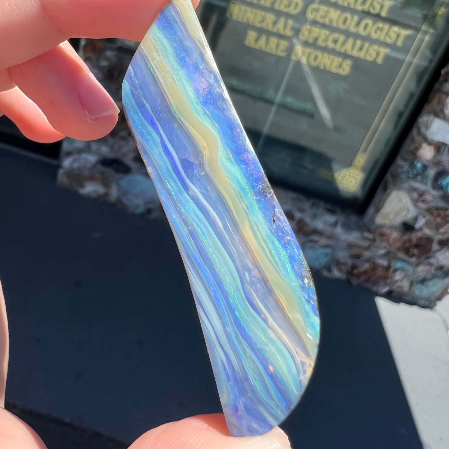 A large, loose, polished Quilpie boulder opal stone from Queensland, Australia.  The stone is blue.