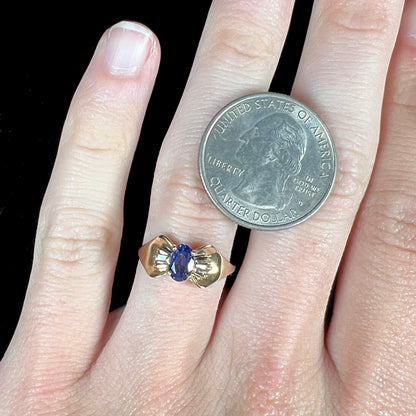A natural blue sapphire and diamond baguette ring cast in yellow gold.