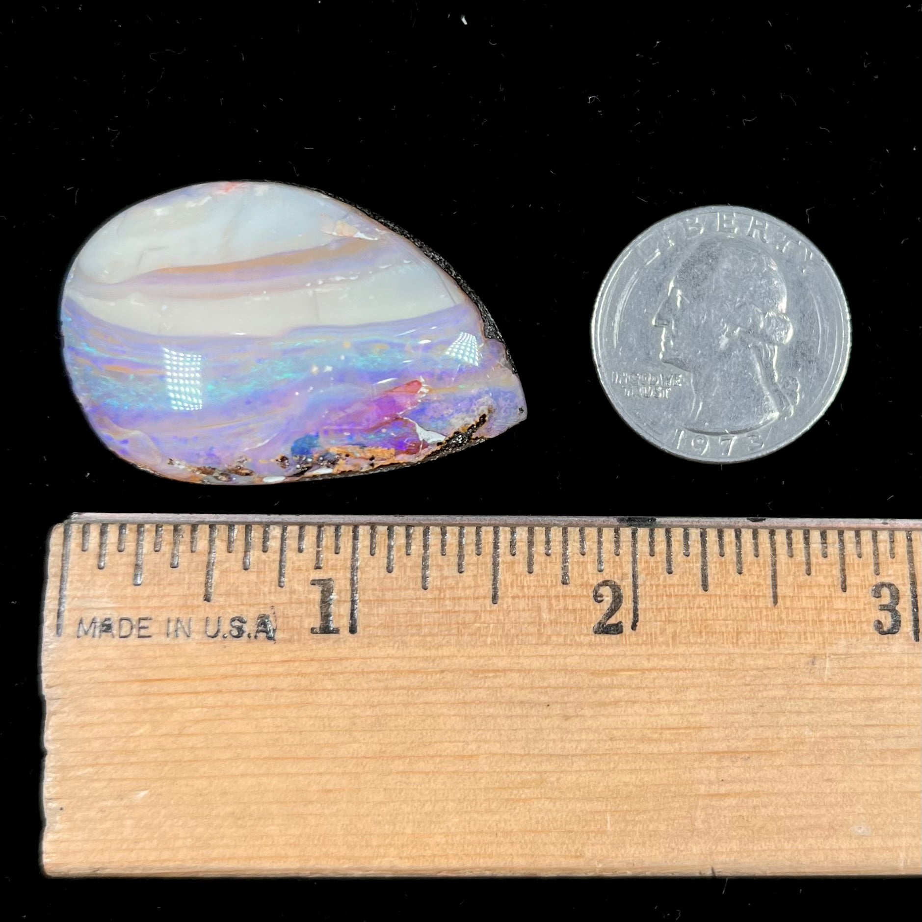 A loose, drop shaped Australian boulder opal from Quilpie Mining District.