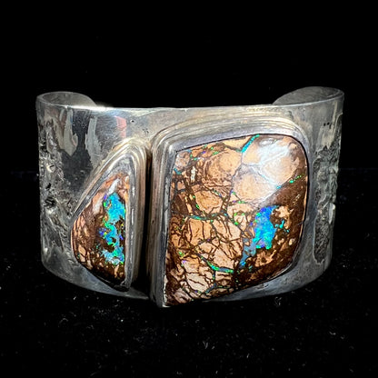 A men's sterling silver and copper infused cuff bracelet set with two boulder opal stones from Koroit, Australia.