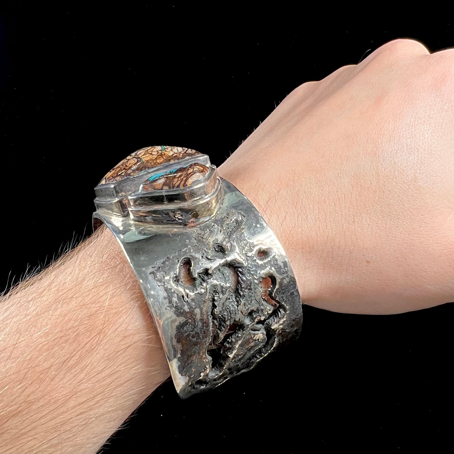 A men's sterling silver and copper infused cuff bracelet set with two boulder opal stones from Koroit, Australia.