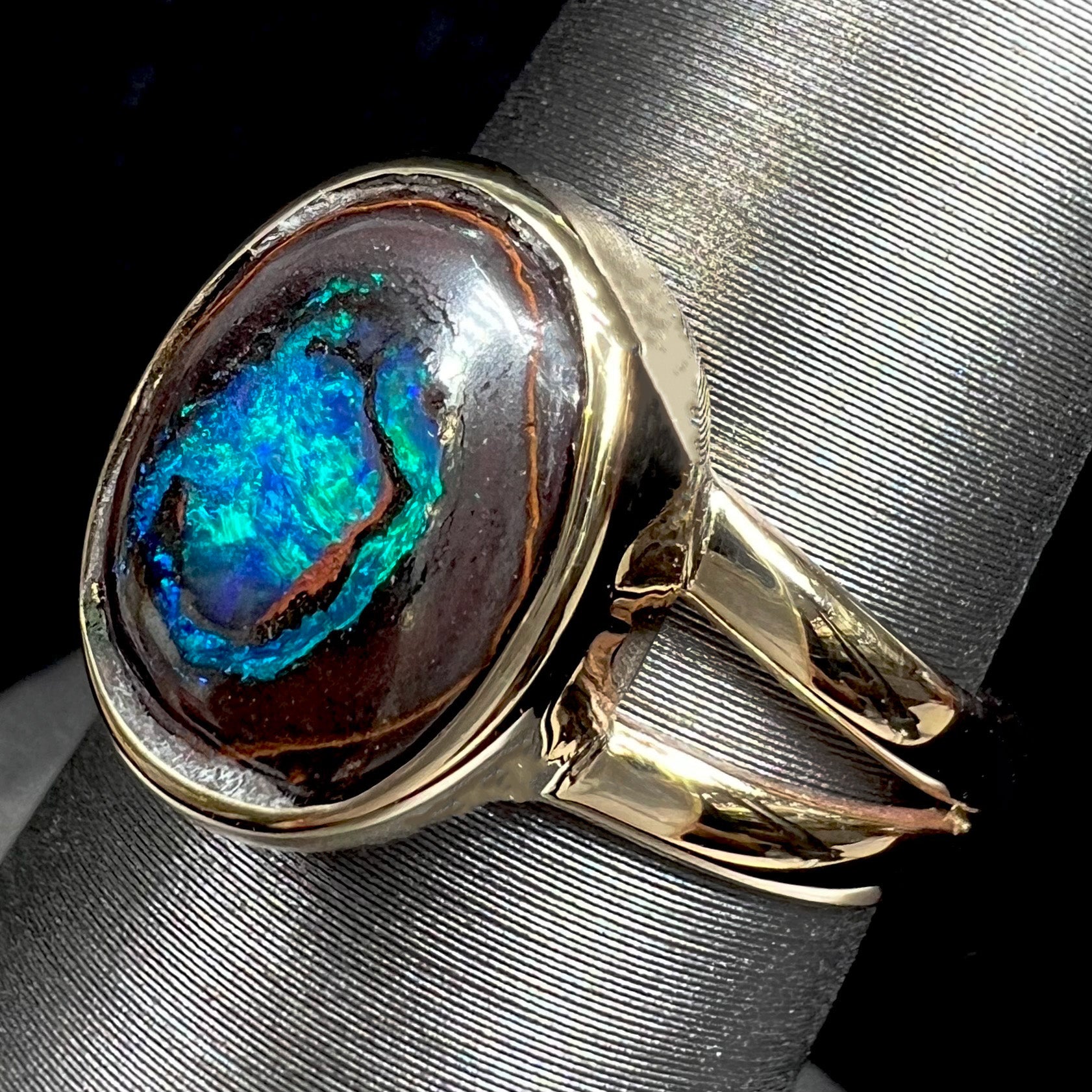 A natural Yowah Nut boulder opal split shank ring in 14kt yellow gold.