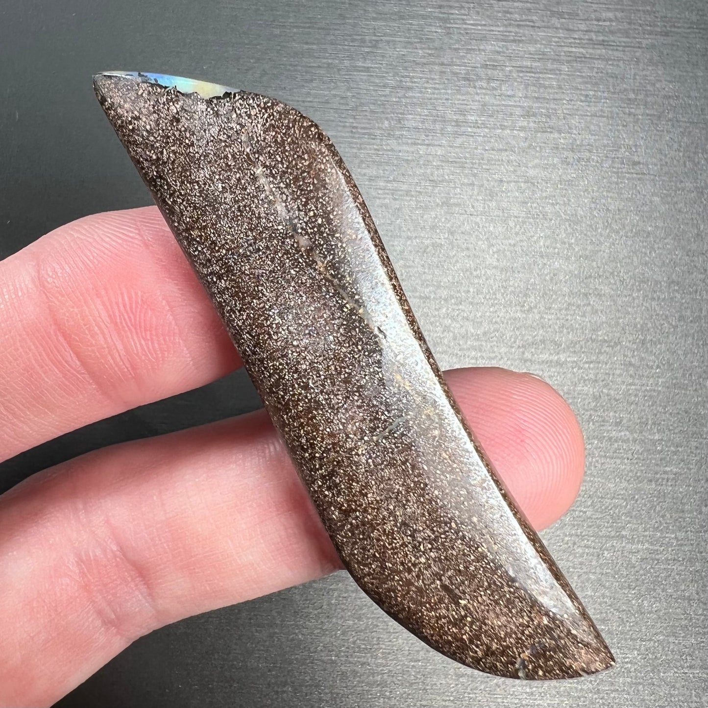 A large, loose, polished Quilpie boulder opal stone from Queensland, Australia.  The stone is blue.