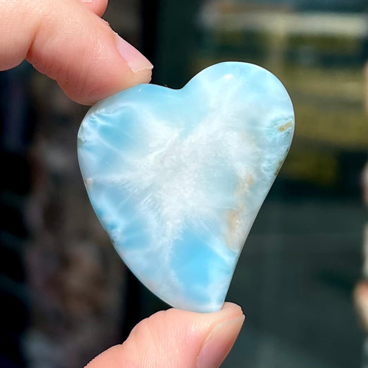 A loose, carved, heart shaped larimar stone.  Predominant colors are blue and white.