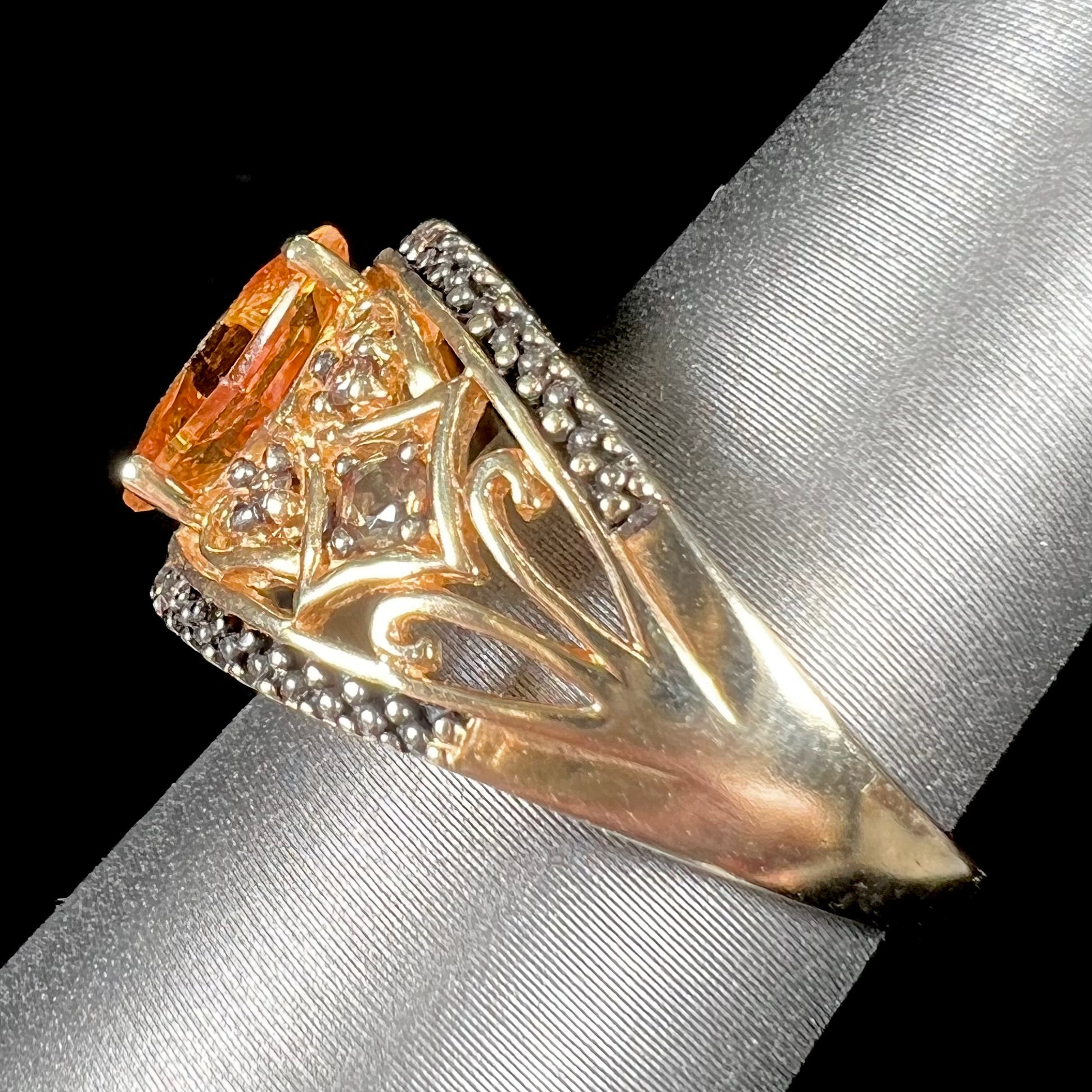 A square cut citrine and chocolate diamond filigree ring with andalusite accents.
