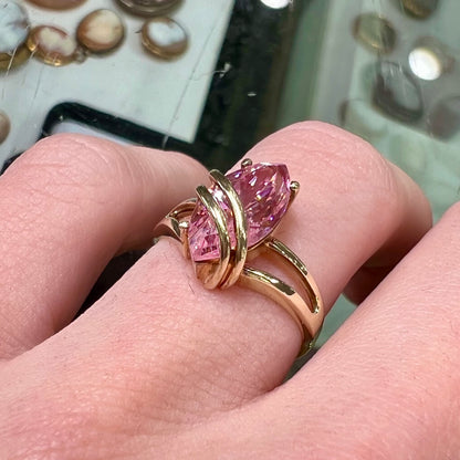 A yellow gold marquise cut pink cubic zirconia ring.