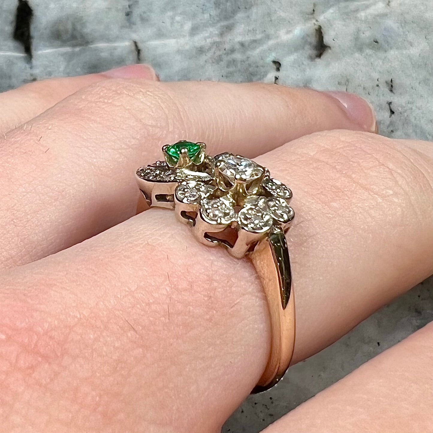 Vintage gold round cut emerald and diamond ring.