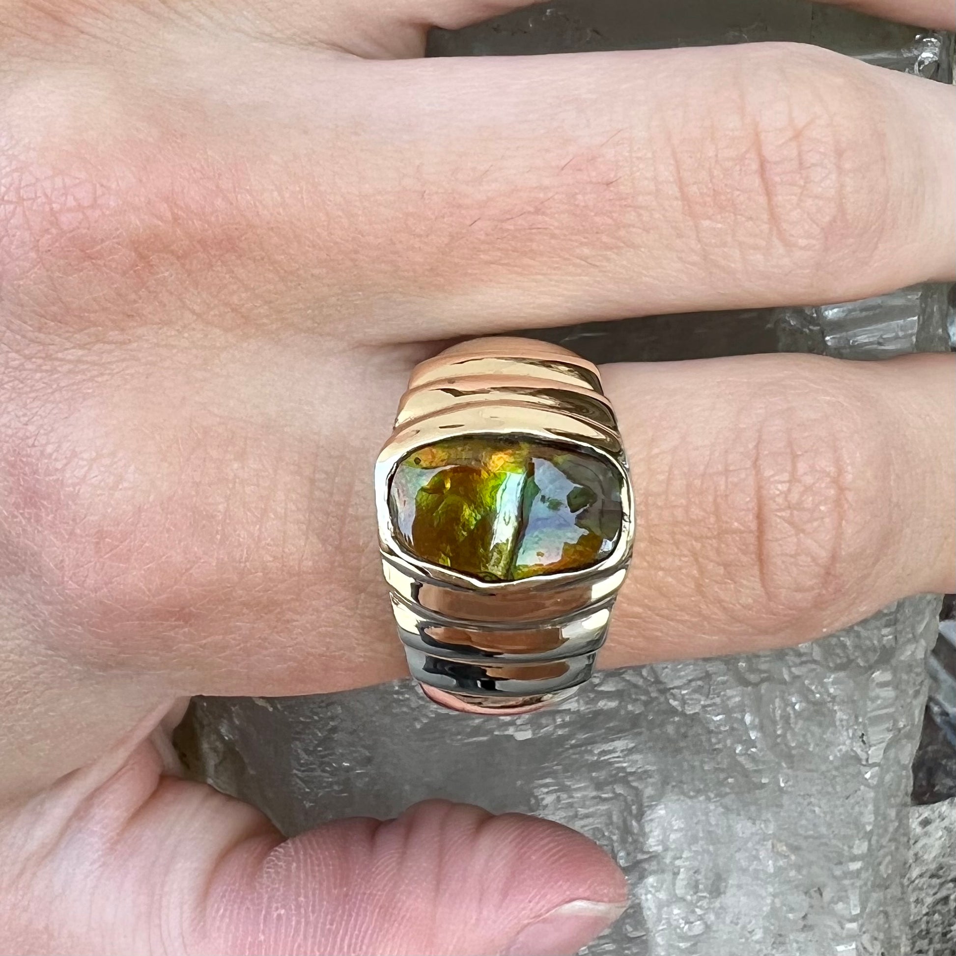 Men's fire agate solitaire ring cast in yellow gold.  The ring is a step design.