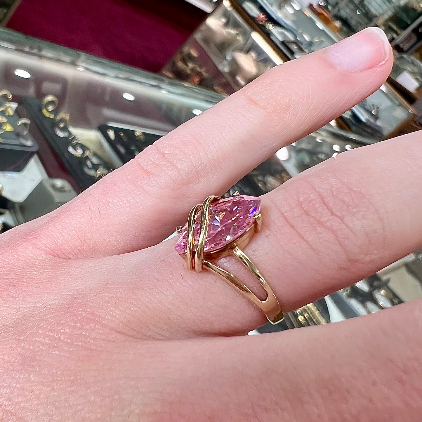 A yellow gold marquise cut pink cubic zirconia ring.