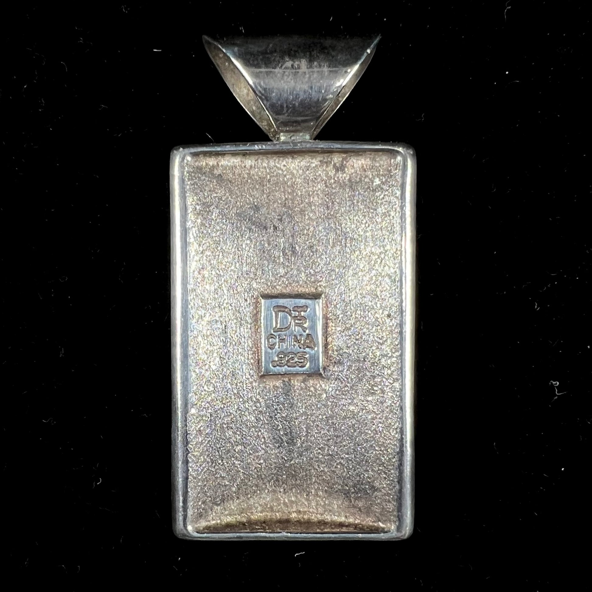 A silver pendant set with square cabochon cut turquoise and coral stones.  The piece is stamped "DTR CHINA".