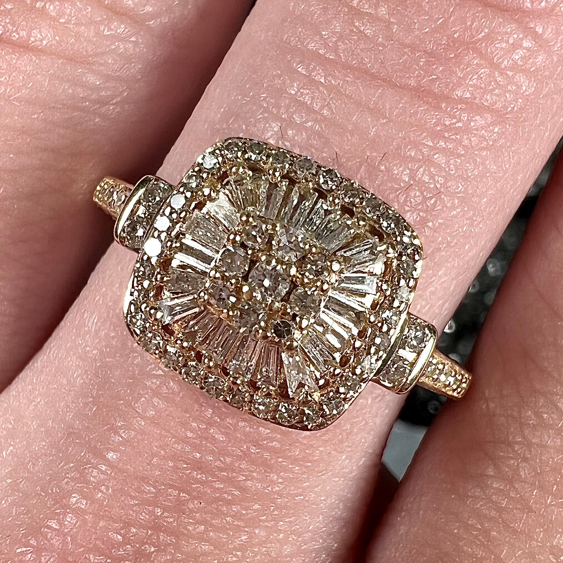 A 1930's style yellow gold diamond cluster ring set with round and baguette cut diamonds.