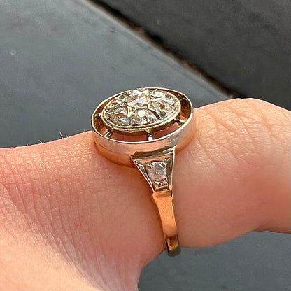 An antique yellow gold ring set with a cluster of old European cut diamonds.