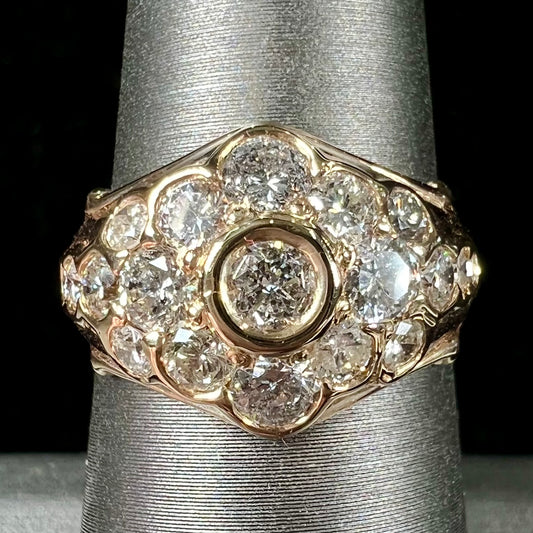 A yellow gold domed diamond ring set with 19 Standard Round Brilliant Cut diamonds.