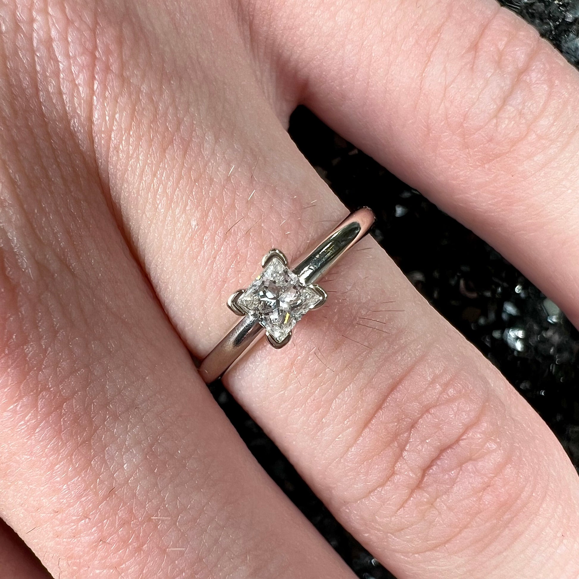 A quarter carat princess cut diamond solitaire engagement ring in white gold.