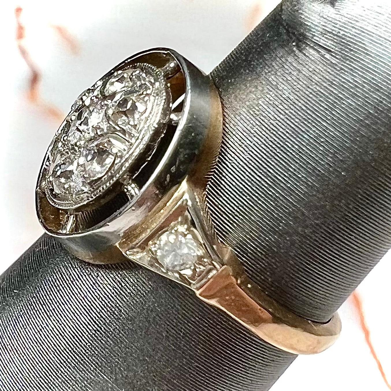 An antique yellow gold ring set with a cluster of old European cut diamonds.