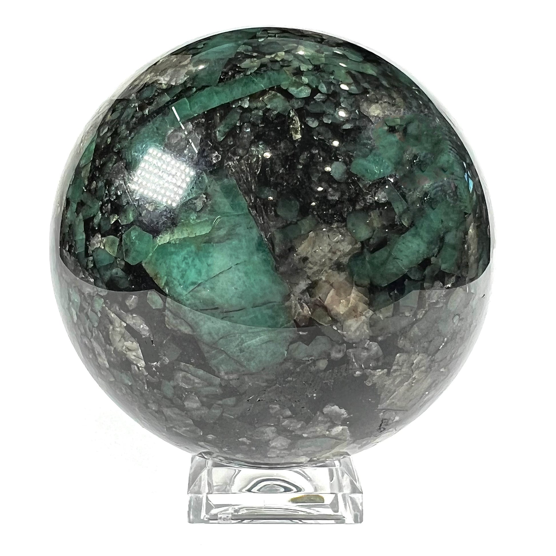 A gemstone sphere carved from a natural emerald crystal specimen, measuring 2.2 inches in diameter.