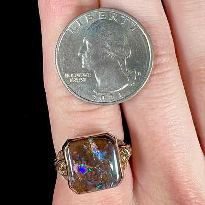 An antique yellow gold boulder opal ring.  The stone is a sqaure cut natural opal from Quilpie, Australia.