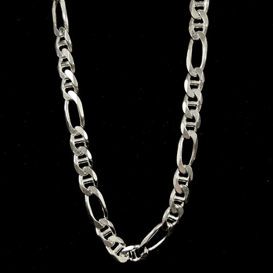 A men's sterling silver figaro anchor chain.  The chain measures 22 inches in length and the links are 11mm wide.