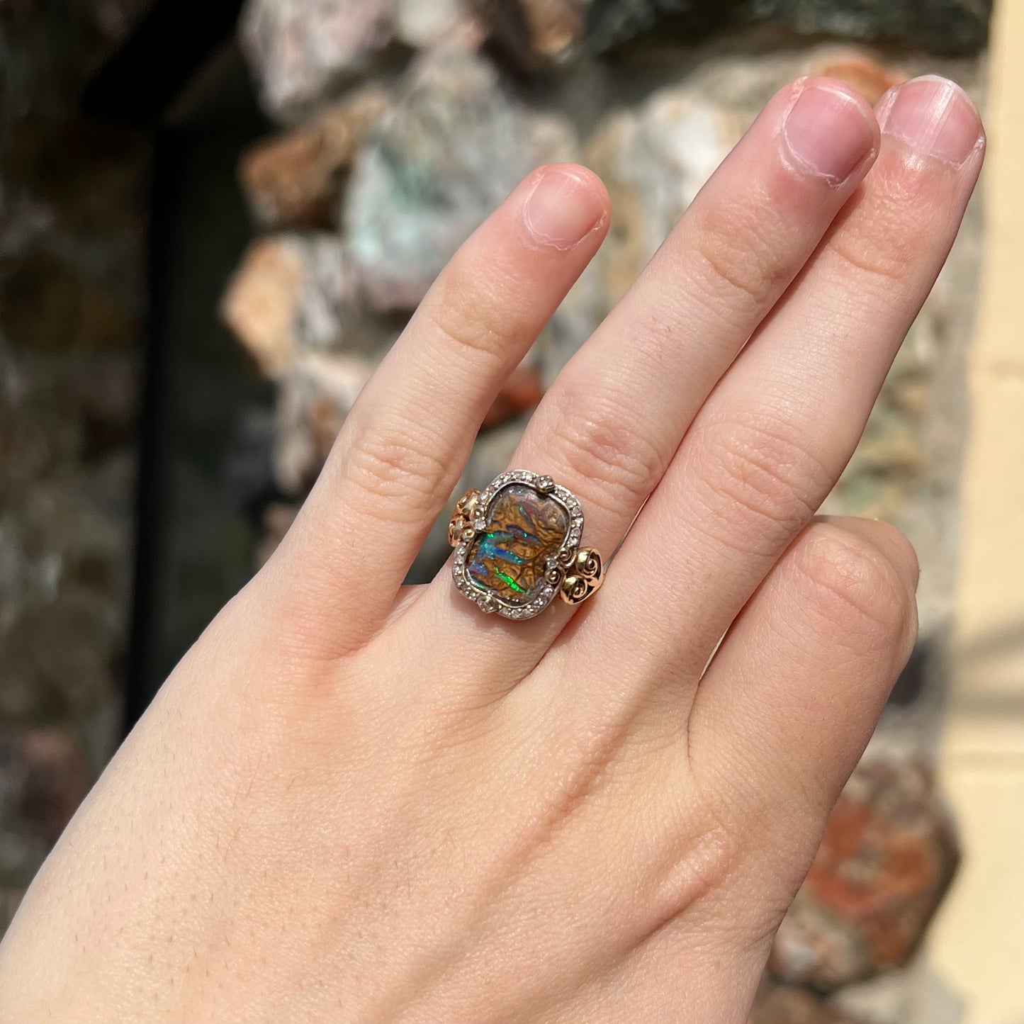 Striped Koroit boulder opal set in a filigree 14k yellow gold setting with diamonds.  The filigree has a heart pattern.