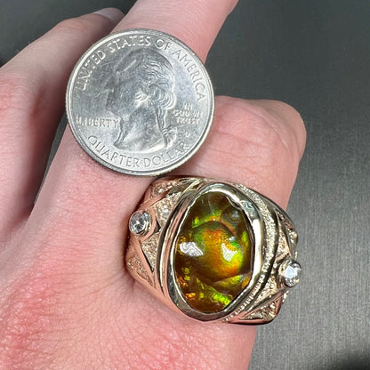 A men's solid yellow gold fire agate and diamond ring.  The fire agate displays predominantly red and green.