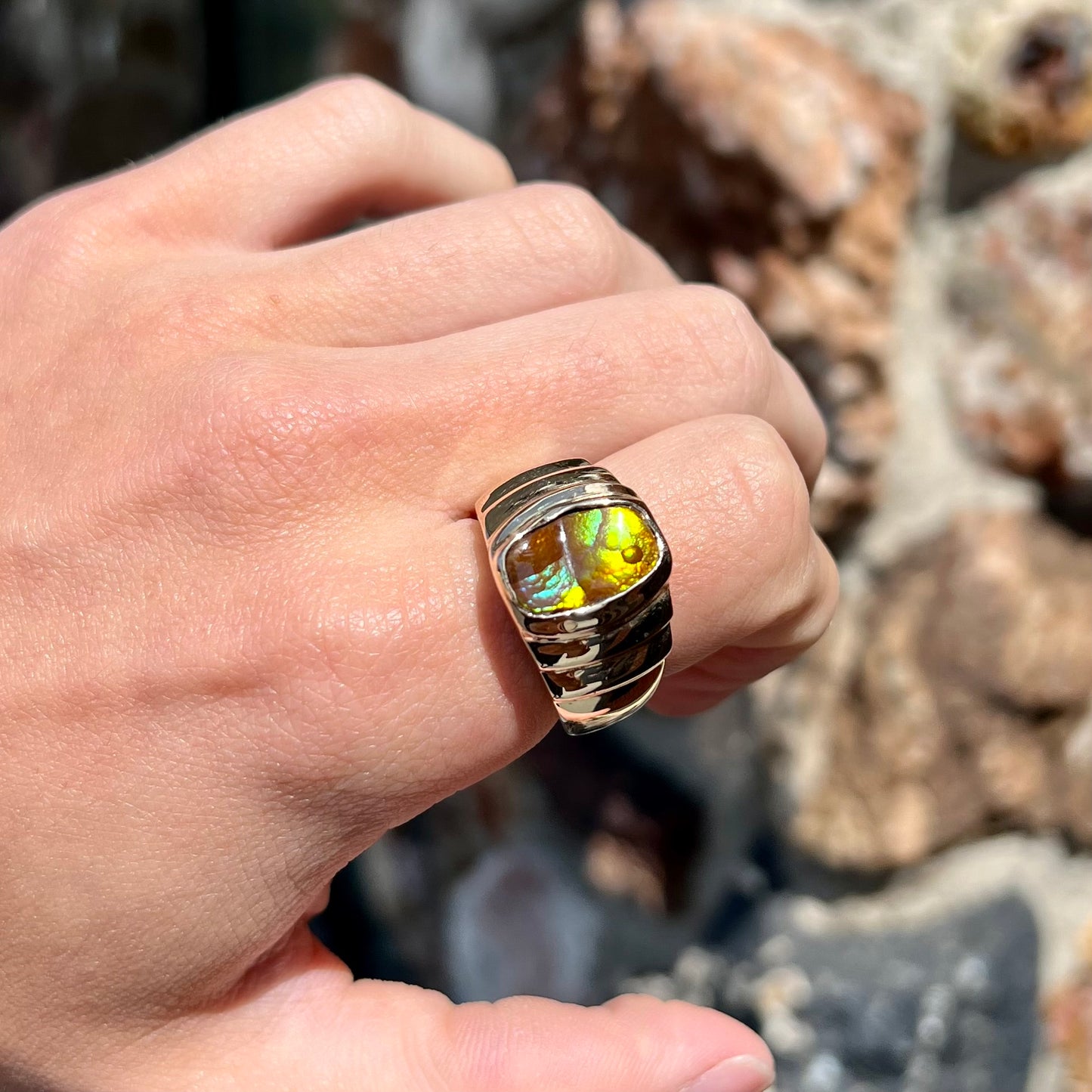 Men's fire agate solitaire ring cast in yellow gold.  The ring is a step design.