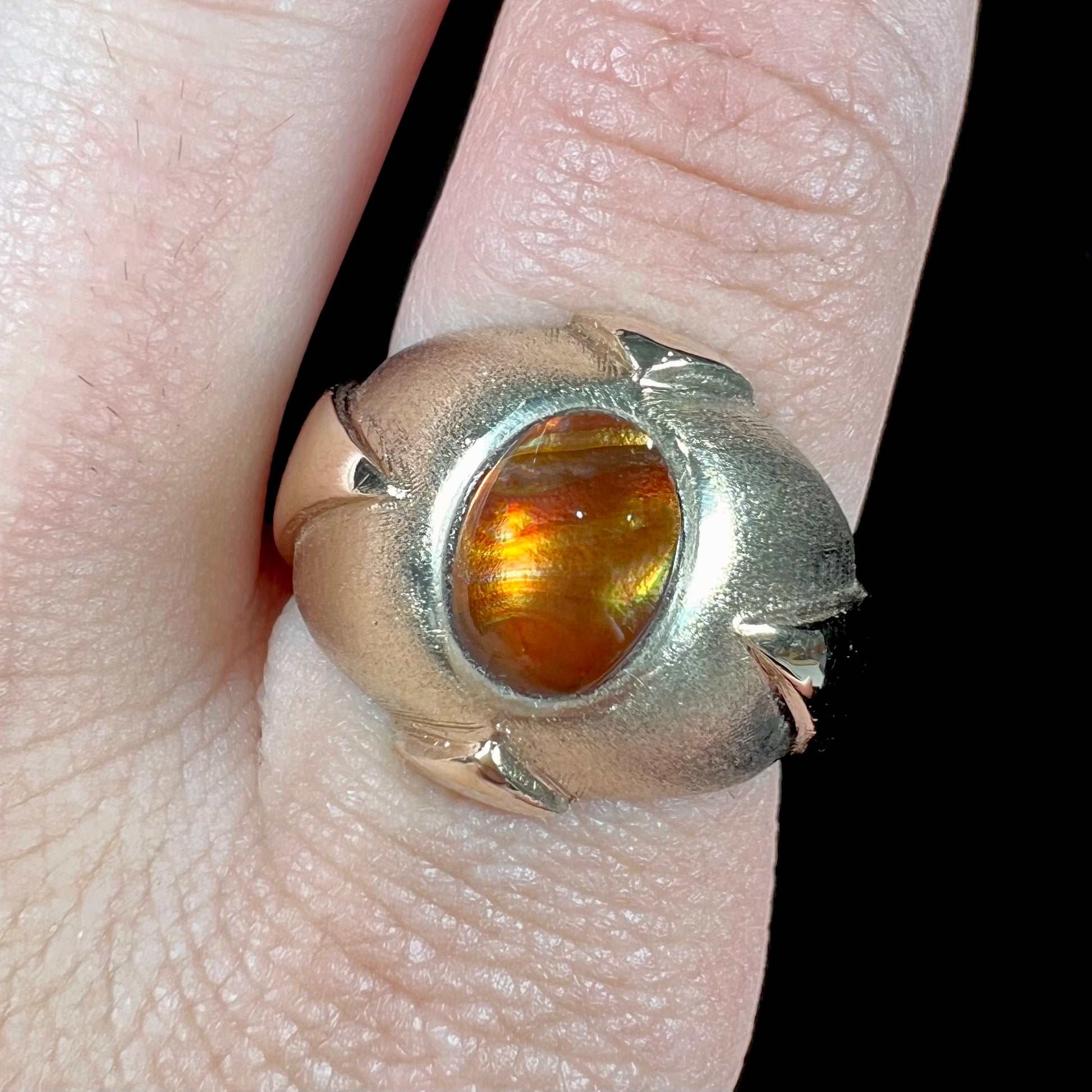 A men's brushed yellow gold fire agate ring with polished accents.