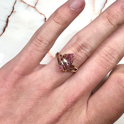 A yellow gold marquise cut pink cubic zirconia ring.