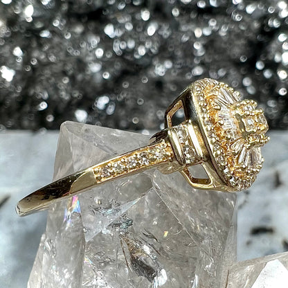 A 1930's style yellow gold diamond cluster ring set with round and baguette cut diamonds.