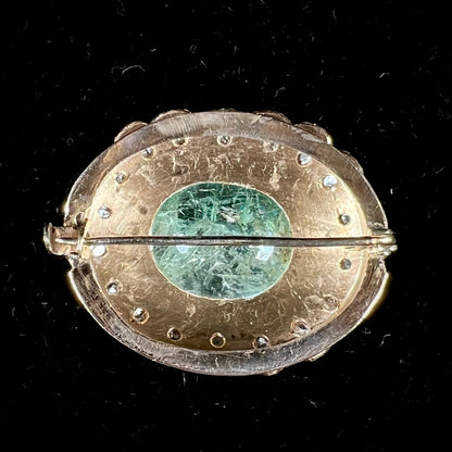 An antique 1800's Victorian emerald and diamond crystal brooch made in 18kt yellow gold.