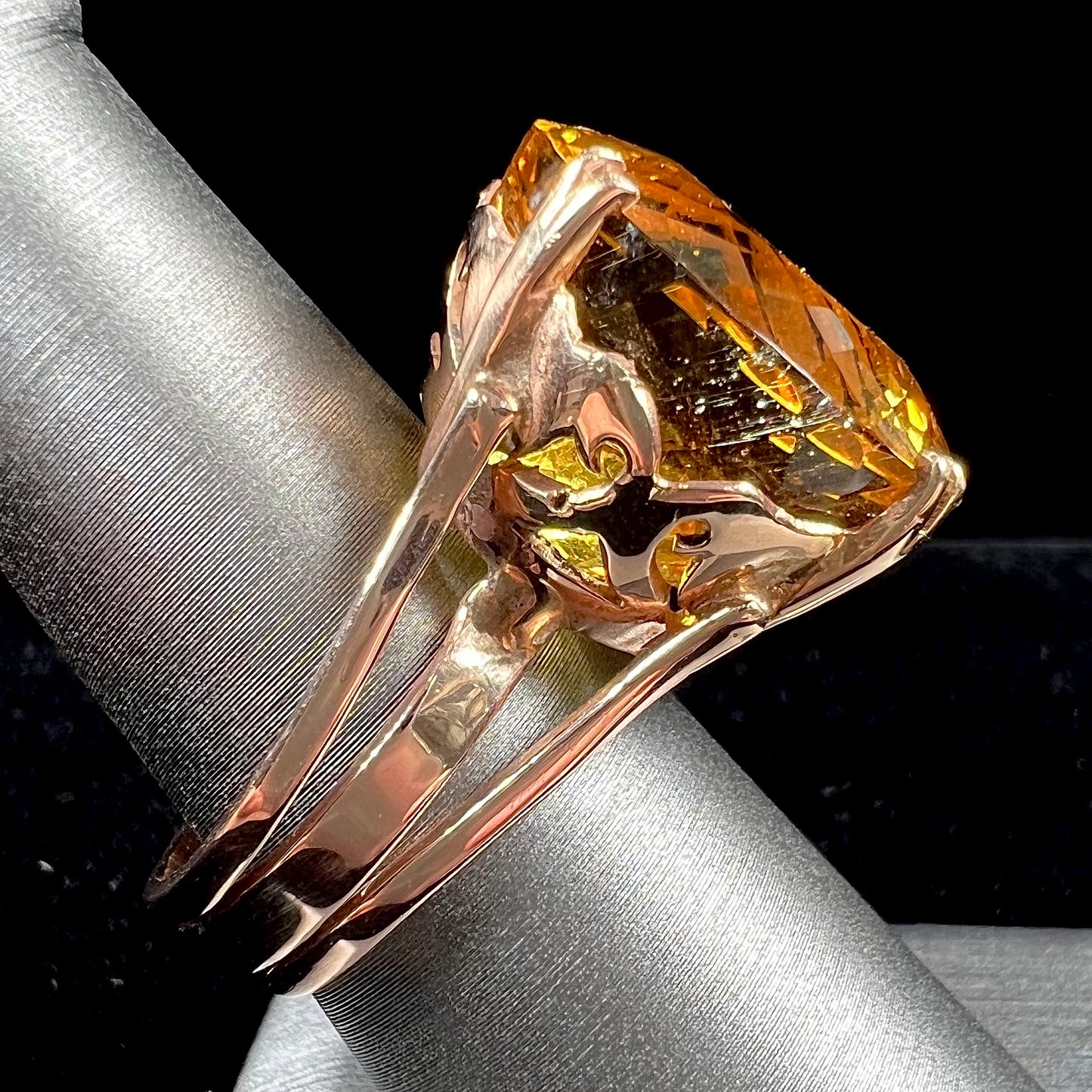 A rose gold solitaire ring set with a 51.20 carat round brilliant cut golden beryl stone.