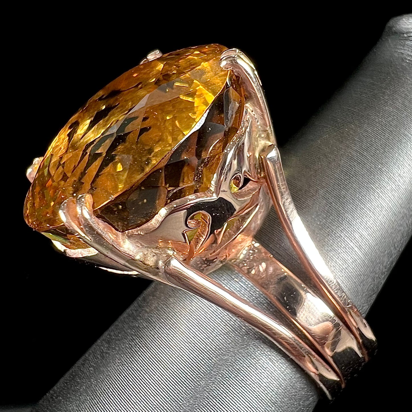 A rose gold solitaire ring set with a 51.20 carat round brilliant cut golden beryl stone.