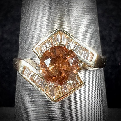 A yellow gold ladies' golden topaz ring set with baguette cut side diamonds.