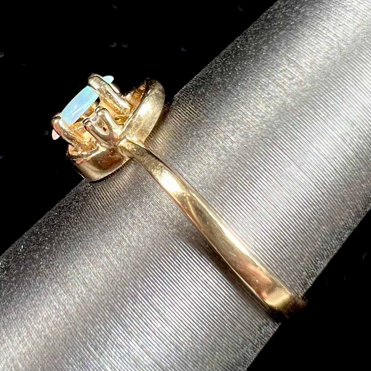 A dainty ladies' yellow gold opal and diamond accent ring.