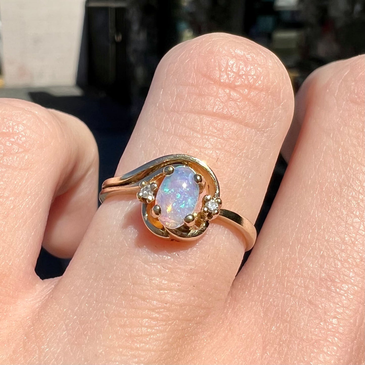 A dainty ladies' yellow gold opal and diamond accent ring.