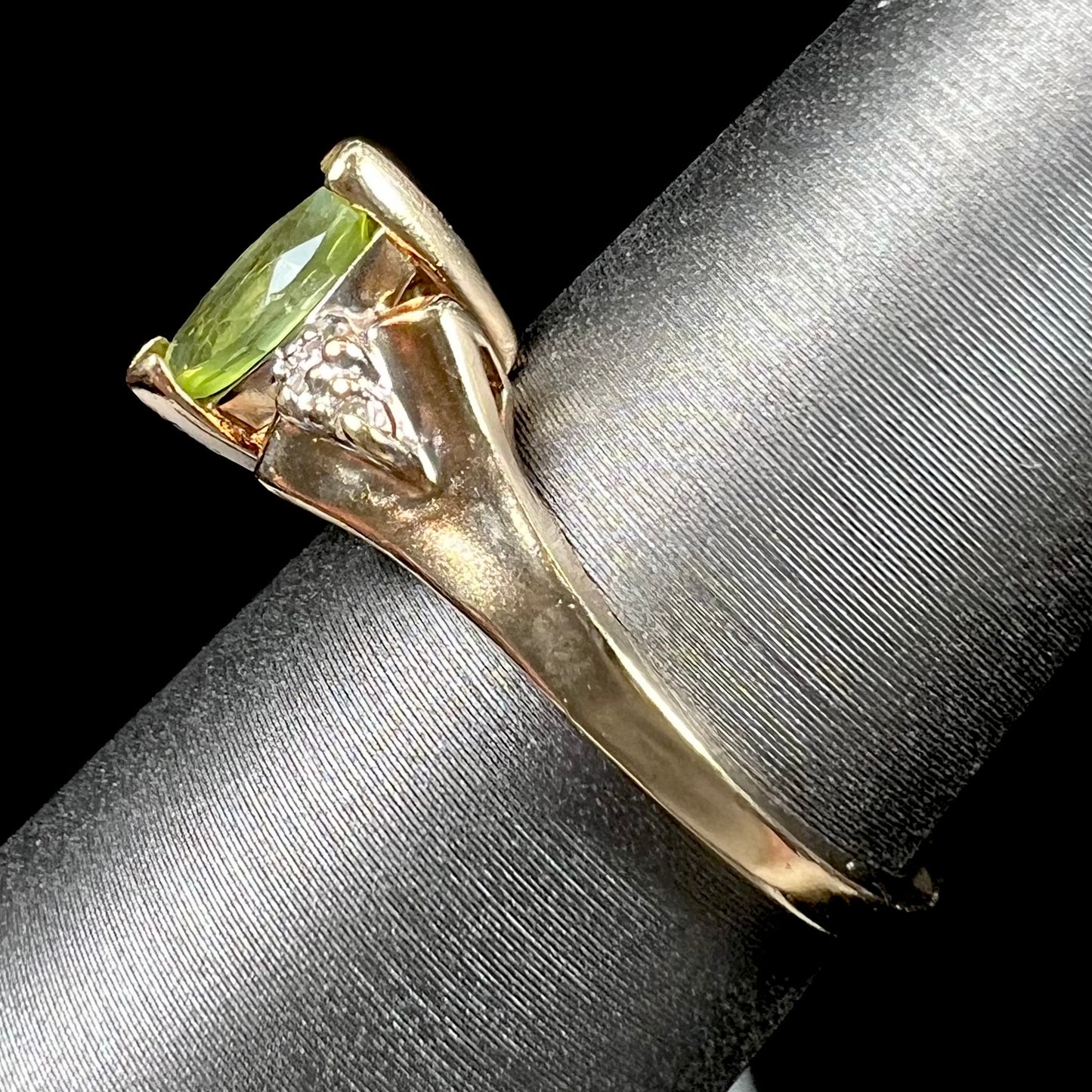 A ladies' marquise cut peridot and diamond ring in 10 karat yellow gold.